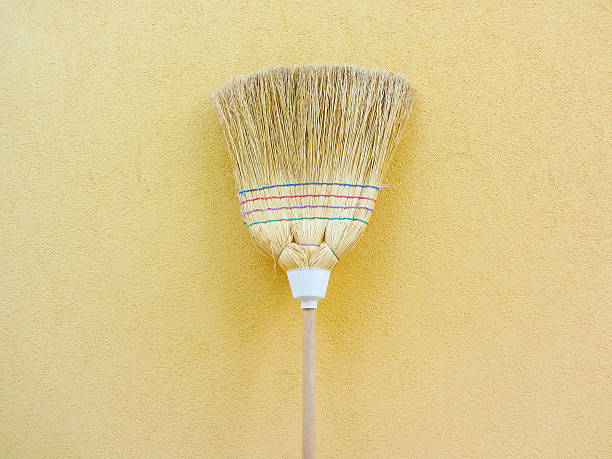 istock isolated country broom on yellow background 616112672