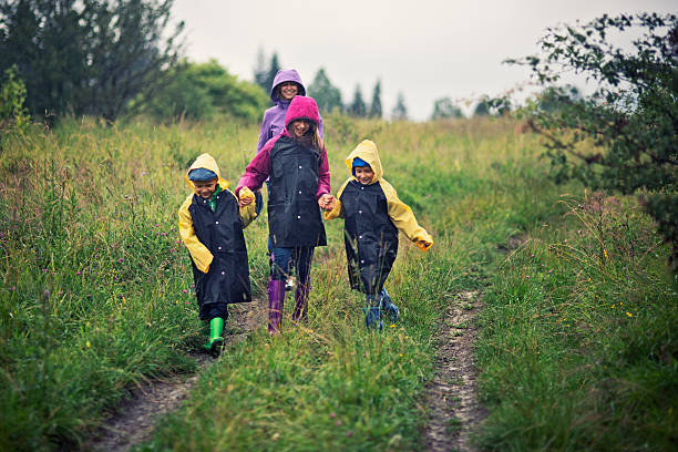 familienwandern im regen - drenched raincoat rain clothing stock-fotos und bilder
