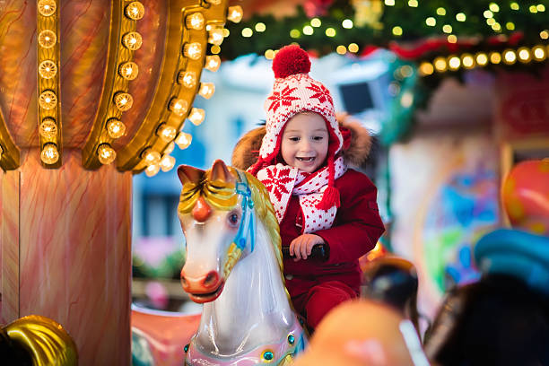 istock Child riding carousel on Christmas market 616113974