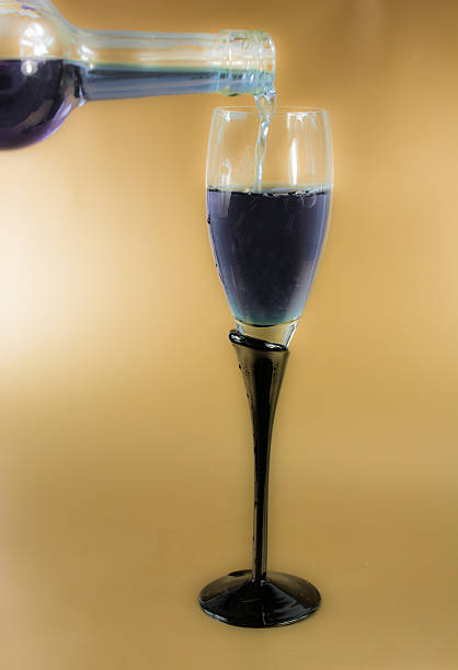 Wine glass on  gold background- being filled