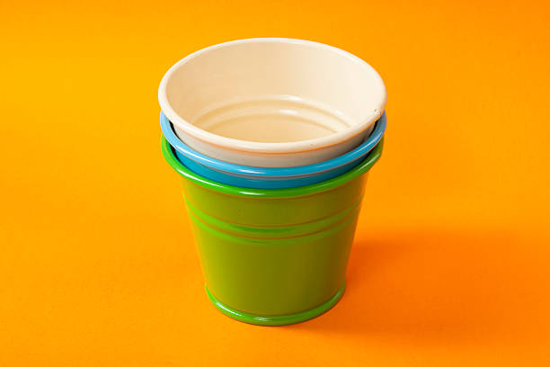 istock Colorful buckets on orange background 616115440