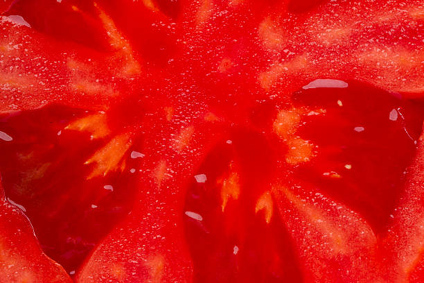 istock bright red tomato in a cut closeup 616115464
