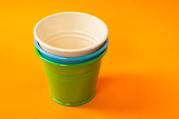 istock Colorful buckets on orange background 616115490