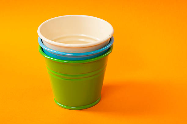istock Colorful buckets on orange background 616115536