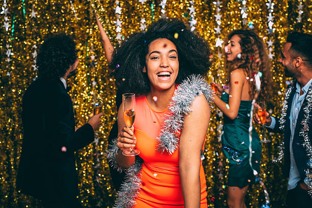 Woman At A New Year's Eve Party A portrait of a woman celebrating New Year's Eve with friends. new year photos stock pictures, royalty-free photos & images