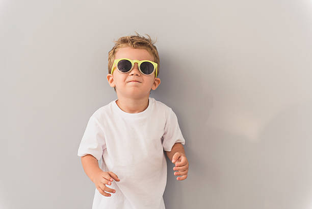 istock Little boy in sunglasses posing in studio 616117686