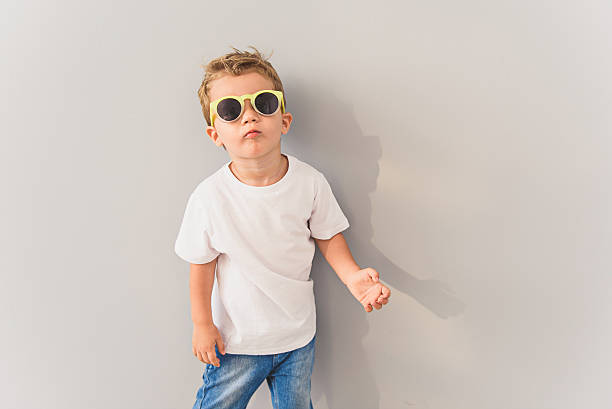 istock Little boy in sunglasses posing in studio 616117778
