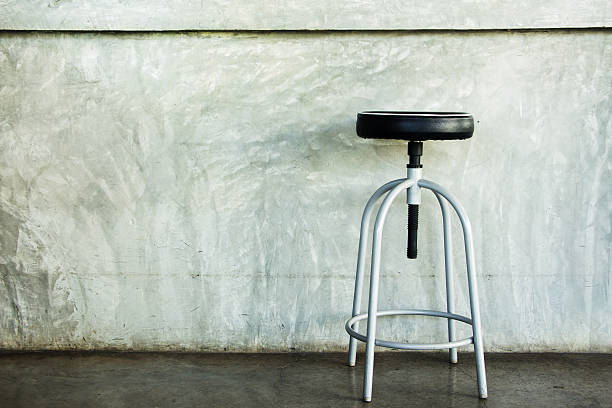istock Elegant chair in an empty concrete room. 616118280