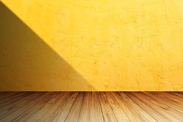 istock Bright orange concrete wall against perspective wood 616118320