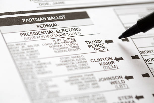 Vote For Donald Trump in Presidental Election Phoenix, Arizona, USA - October 21, 2016: Close up of a pen about to mark the 2016 USA general election early voting ballot form with a vote for Donald Trump as president. hillary clinton stock pictures, royalty-free photos & images