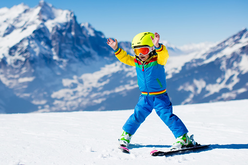 Little toddler child skiing in the mountains