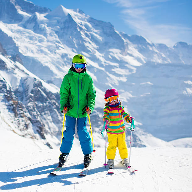 istock Active children skiing in the mountains 616120434