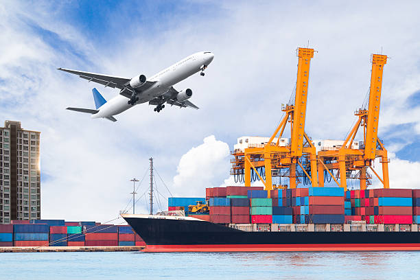 Container cargo freight ship with working crane loading bridge stock photo