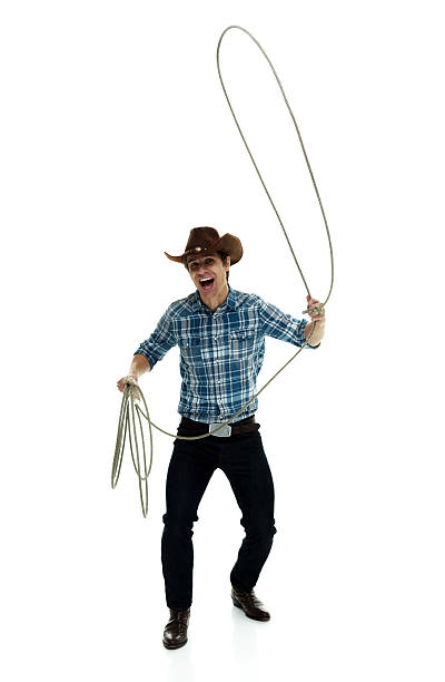 istock Cheerful cowboy lassoing 616128774