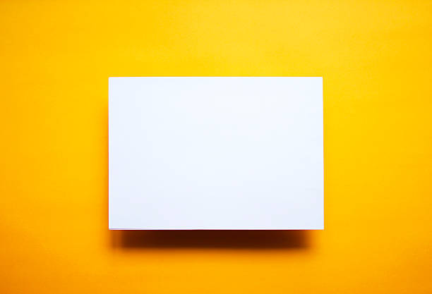 Empty white paper sheet isolated yellow background Empty white paper sheet isolated on yellow background artists canvas photos stock pictures, royalty-free photos & images