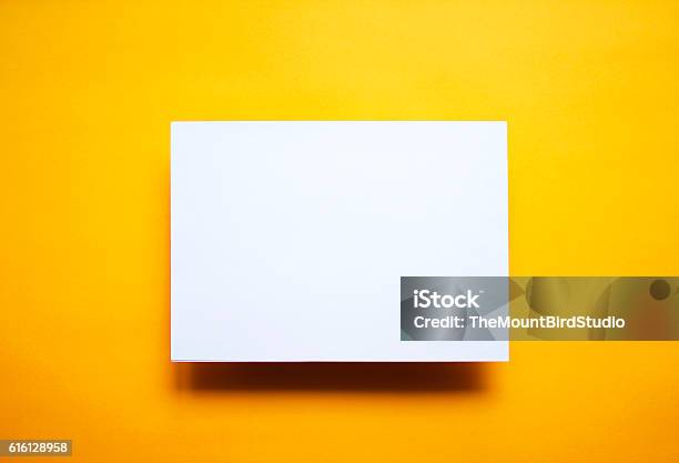 Empty White Paper Sheet Isolated Yellow Background Stock Photo - Download Image Now - Template, Poster, Photographic Print
