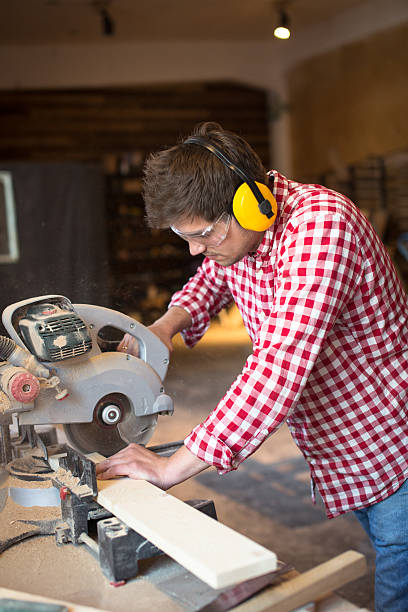 istock master carpenter with headphones and glasses saws  board circula 616130684
