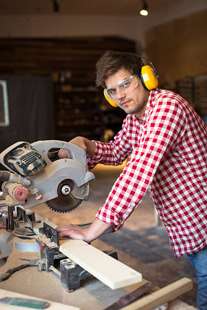 istock master carpenter with headphones and glasses saws  board circula 616130794