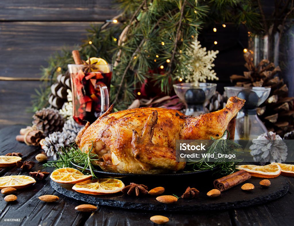 Baked chicken for Christmas or New Year Roast chicken or turkey for Christmas and New Year with mulled wine and Christmas decorations, selective focus Christmas Stock Photo