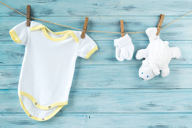 istock Baby clothes and white bear toy on a clothesline 616134186