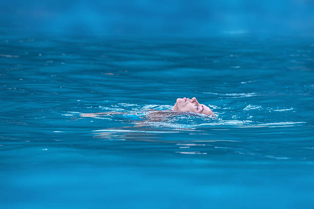 istock Woman relaxing in tropical ocean 616135450