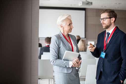 Woman showing a place of meeting to a business person