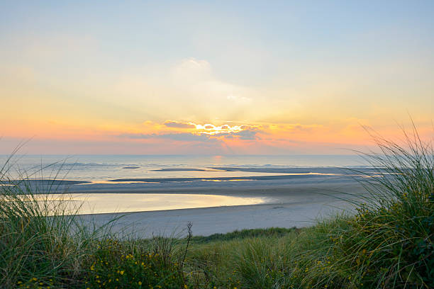 istock View from the dunes of a sunset at the beach 616219136
