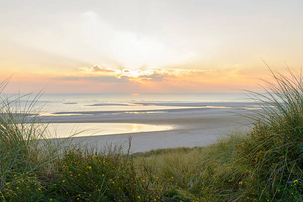 istock View from the dunes of a sunset at the beach 616219180