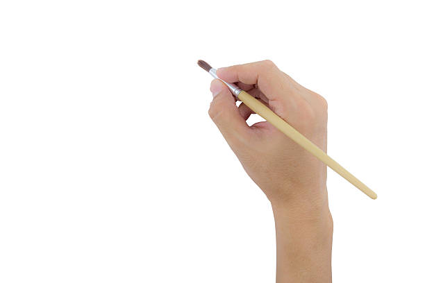 istock hand holding paint brush isolated over white background 616220676