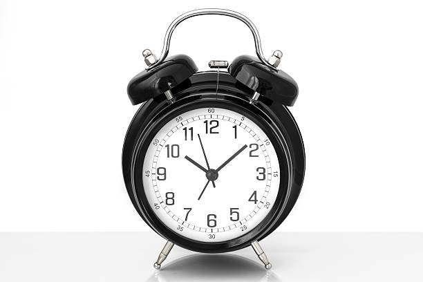 istock Black vintage alarm clock with white background 616221388