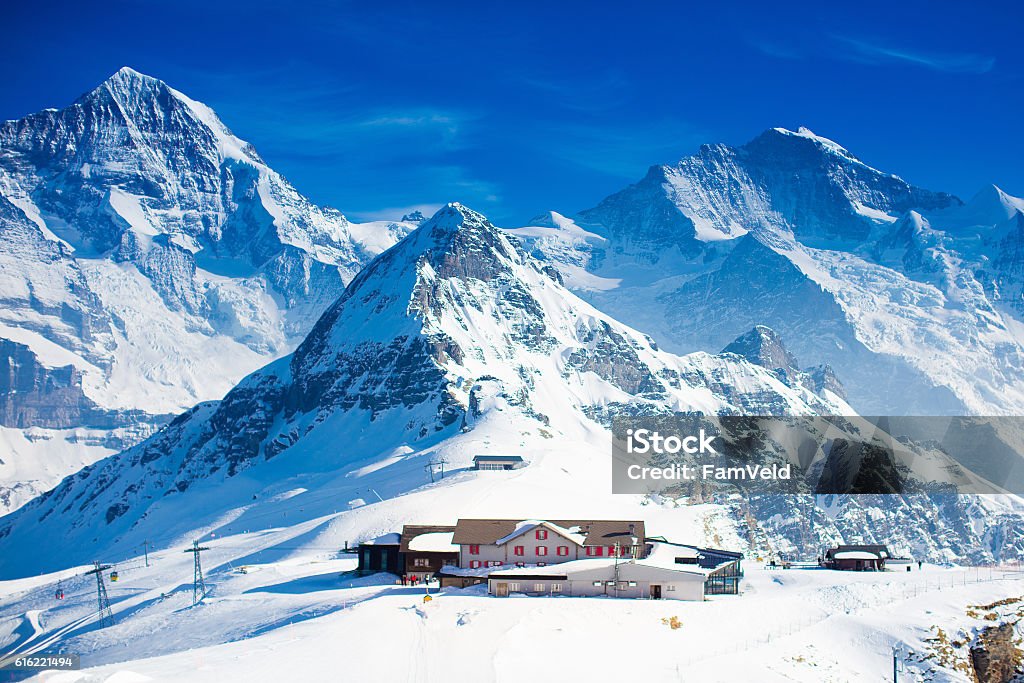 Aerial view of the Alps mountains in Switzerland Aerial view of the Alps mountains in Switzerland. View from helicopter above glacier in Swiss Alps. Mountain tops covered in snow. Alpine ski facilities from above. Grindelwald Stock Photo