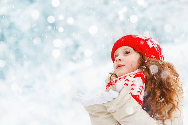 istock Child to catch falling snowflakes. 616221526