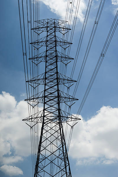istock electricity transmission lines and pylon 616221672