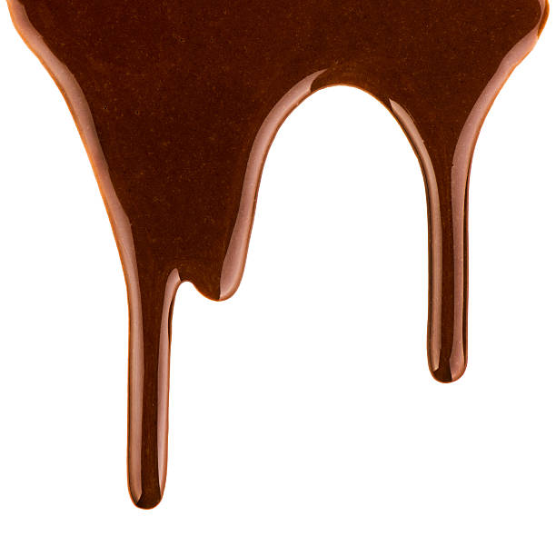 istock streams of milk chocolate on white background 616221862