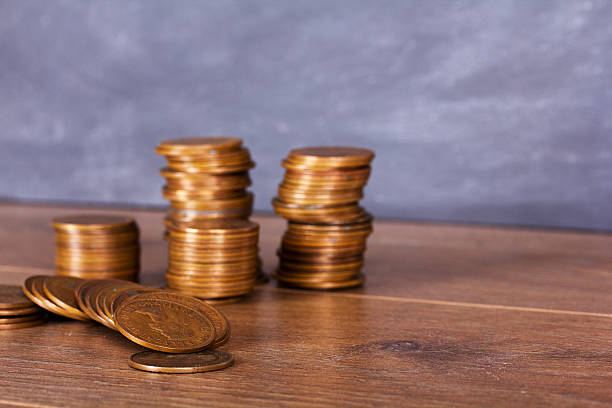 istock Stack of penny coins on a wooden surface 616222624