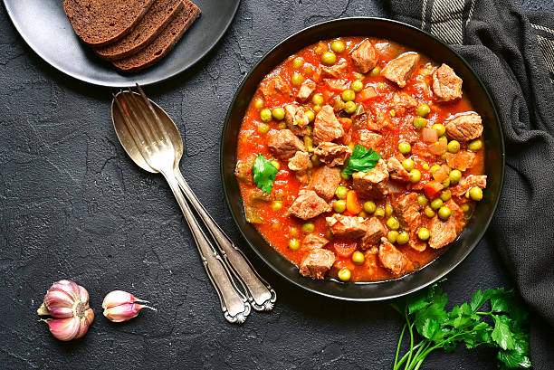 istock Veal stewed with vegetables in tomato sauce.Top view. 616224074