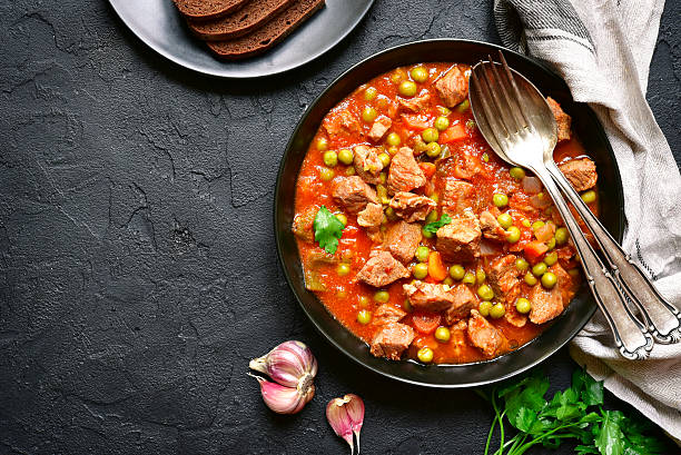 istock Veal stewed with vegetables in tomato sauce.Top view.Space for text. 616224782