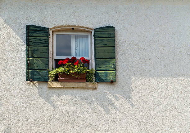 istock Window in an old house decorated with flower 616227410