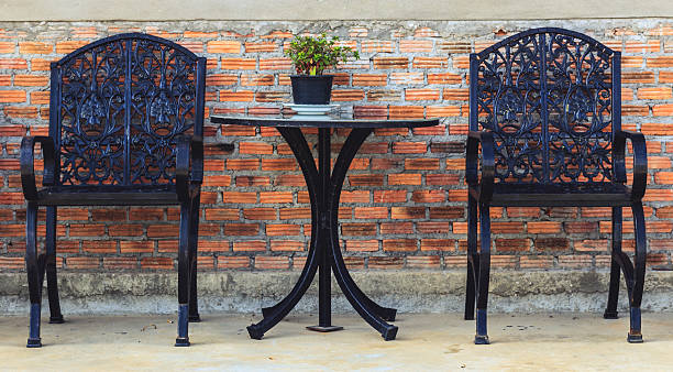 istock Metal chairs and metal table with Brick wall background 616229302