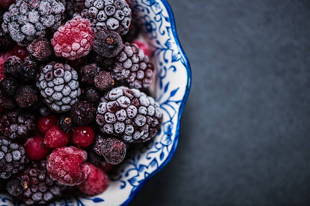 Bowl with frozen black forest fruits stock photo