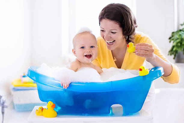 istock Young mother bathing baby boy 616233546