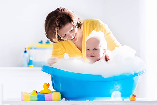 istock Happy young mother bathing baby boy 616234750