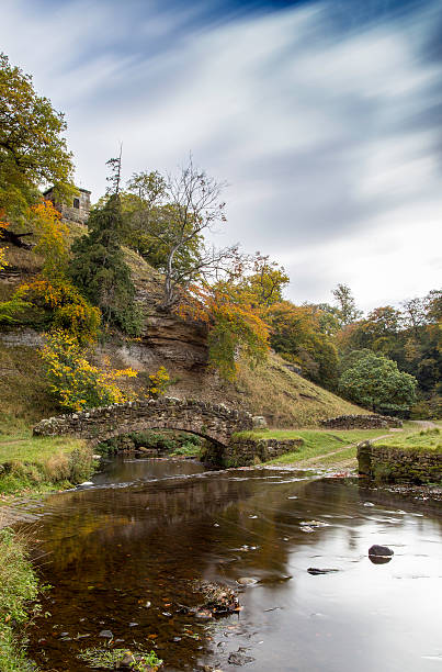 istock Blurred clouds over stone bridge at Fountains Abbey 616235220