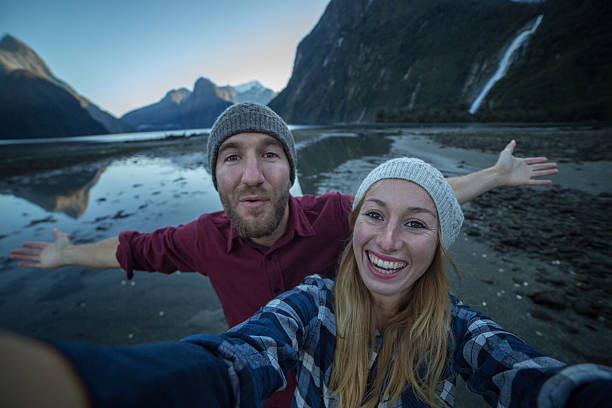 istock Fun couple take selfie portrait with mountain landscape 616235896
