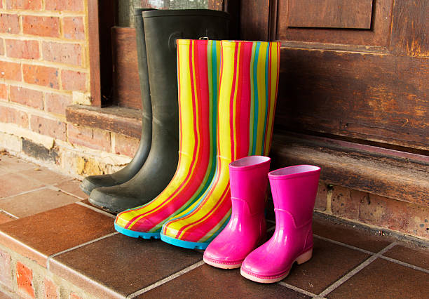istock Colourful wellington boots left on a doorstep 616236056