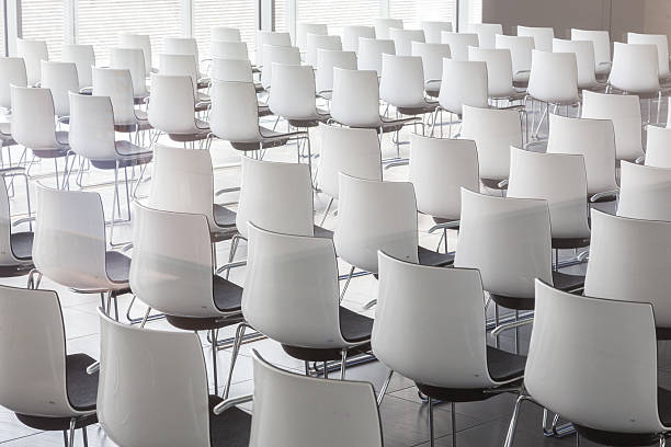 istock Empty white chairs in contemporary conference hall with 616236692