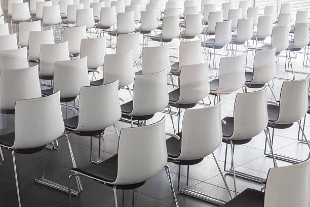 istock Empty white chairs in contemporary conference hall with 616236732