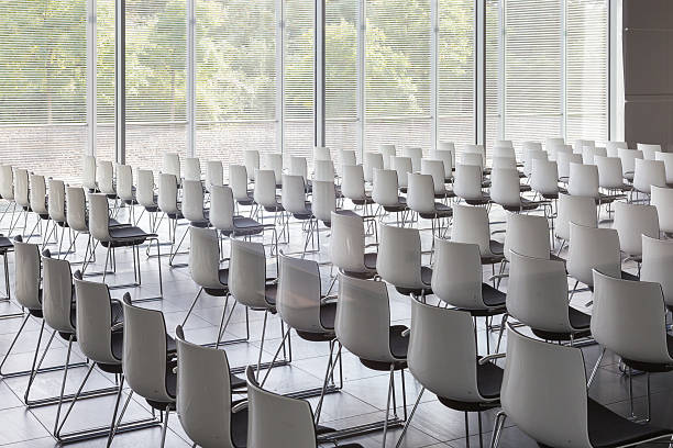 istock Empty white chairs in contemporary conference hall with 616236860