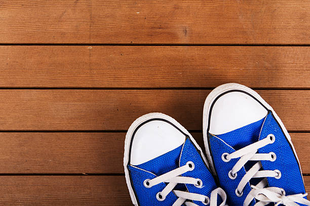 istock Old canvas shoes on a wooden floor 616239348