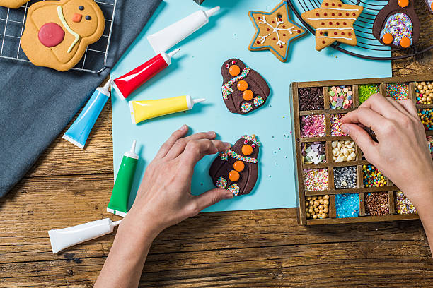 istock Artisan woman decorating Christmas cookies 616240210